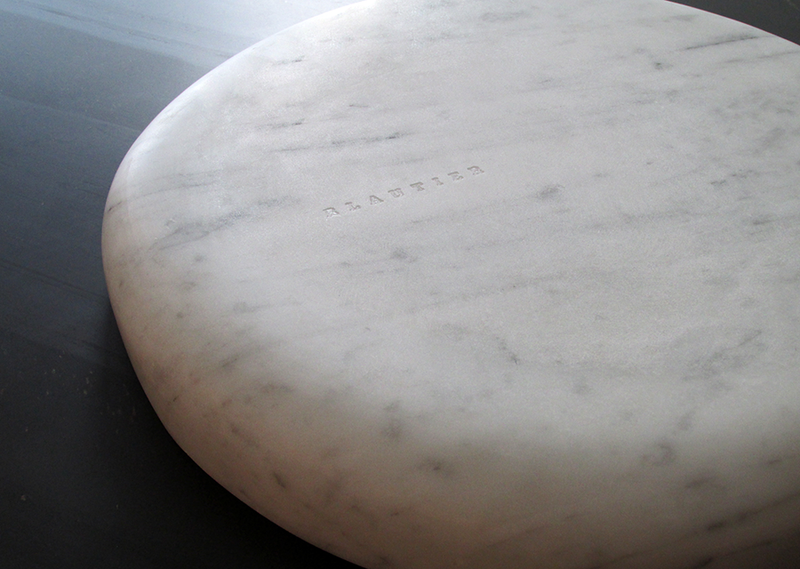 centre plate upside down on black surface white marble centerpiece